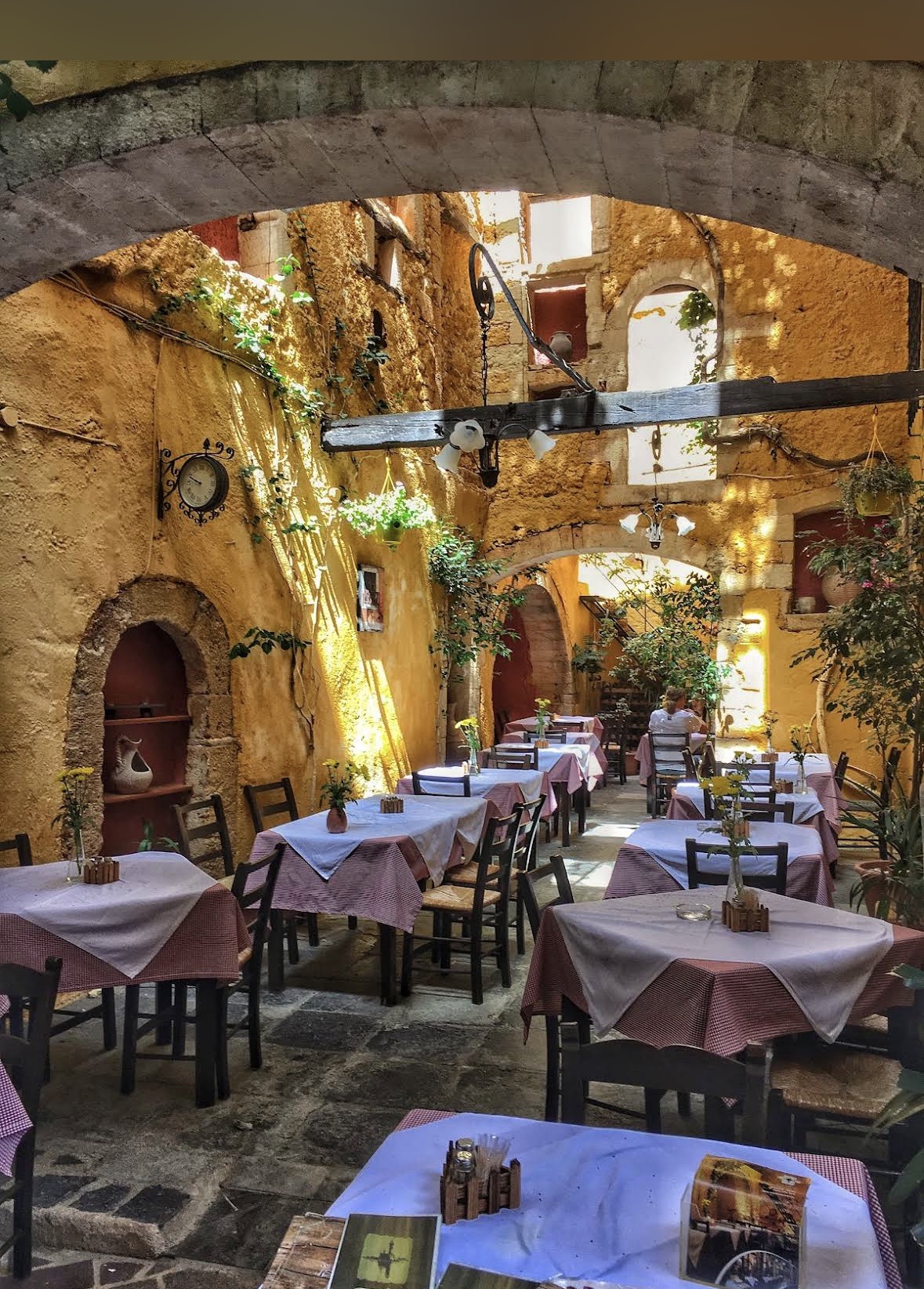 Steki's stone courtyard with vine-covered walls